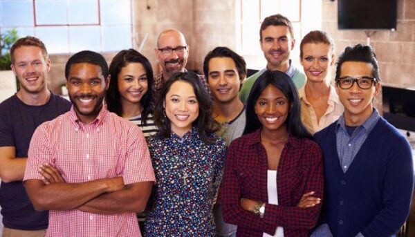 A group of people standing together smiling for the camera.