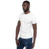 A man in white shirt and jeans posing for the camera.