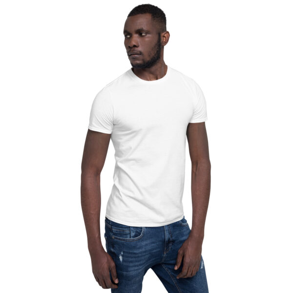 A man wearing jeans and white shirt is looking at the camera.
